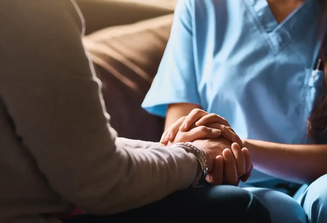 Cropped shot of a nurse holding a senior woman's hands in comfort