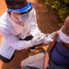Doctor vaccinates child in Africa